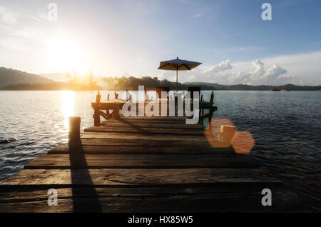 Beach chairs with umbrella and beautiful sand beach on hotel beach lounge in Phuket, Thailand. Summer, Travel, Vacation and Holiday concept Stock Photo