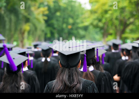 Back of graduates during commencement at university. Close up at graduate cap. Stock Photo