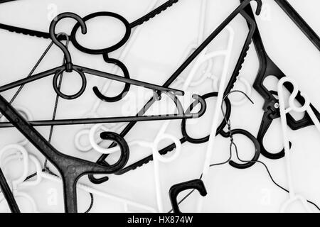 Many hangers of different shapes and colors, top view, white background. Stock Photo