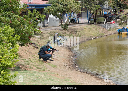 Fisher on the shore of the lake at La Sabana Park in San Jose, Costa Rica Stock Photo