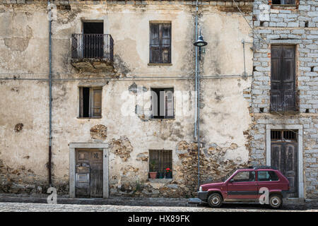 An ruined house and an old car in Fonni, Sardinia Stock Photo