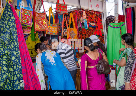 KUTCH, GUJARAT, INDIA - DECEMBER 27, 2016: An unidentified group of people at handicraft shop looking at colorful embroidery items. Stock Photo