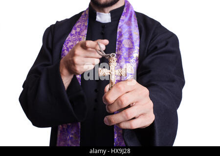 Priest holding Christian Cross. Studio shot isolated on white background Stock Photo