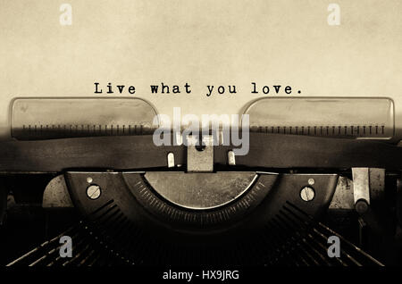 Live what you love Inspirational quotes type on vintage typewriter. Stock Photo