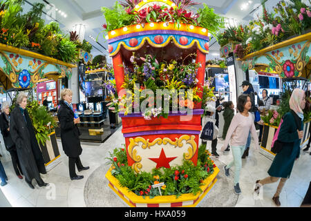New York, USA. 26th Mar, 2017. Macy's flagship department store in Herald Square in New York is festooned with floral arrangements for the 43rd annual Macy's Flower Show, on opening day Sunday, March 26, 2017. Visitors flock to this year's show, whose title and theme is 'Carnival', to enjoy the thousands of flowers in horticultural displays evoking early 20th Century fairs. The show runs until April 9. ( © Richard B. Levine) Credit: Richard Levine/Alamy Live News Stock Photo