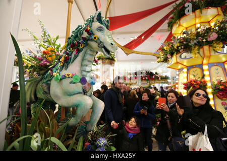 New York, USA. 26th Mar, 2017. People looks around at the Macy's Herald Square store where the 'carnival' themed Macy's flower show kicked off, in Manhattan, New York, the United States, March 26, 2017. The 'carnival' themed Macy's flower show kicked off here on Sunday. The 15-day show, with floral arrangements and organic installations inspired from the iconic American carnival, makes people feel like losing themselves in the quirks and delights of early 20th century fairs. Credit: Wang Ying/Xinhua/Alamy Live News Stock Photo