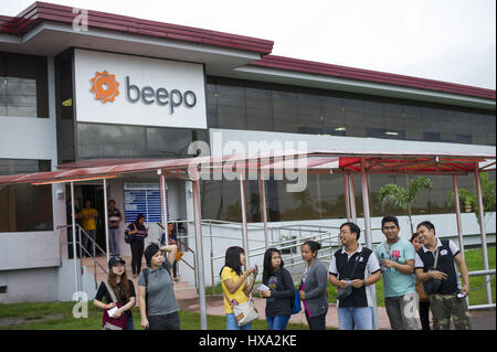 Angeles City, Pampanga, Philppines. 28th Sep, 2016. Business Process Outsourcing employees line up to catch jeepneys, a form of local transport based on re-purposed US Army jeeps, at the end of their working day in front of a call centre operated by Australian firm Beepo. The Clark Freeport Zone has attracted numerous foreign entrepreneurs who have taken advantage of a large pool of native English speakers to employ in Business Process Outsourcing, which includes in bound and outbound call centres and an increasing range of business solutions including accounting and engineering. (Credi Stock Photo