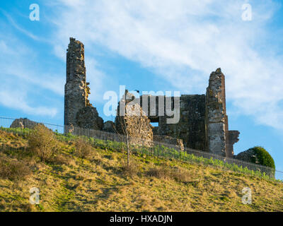 Wispy clouds and blue sky above the historic remainds of Corfe Castle, Corfe Castle, Dorset, UK