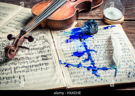 Old violin and sheets on old wooden table Stock Photo