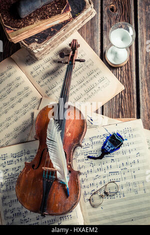 Vintage sheets and violin on old wooden table Stock Photo