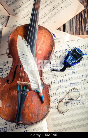 Aged violin and sheets on old wooden table Stock Photo