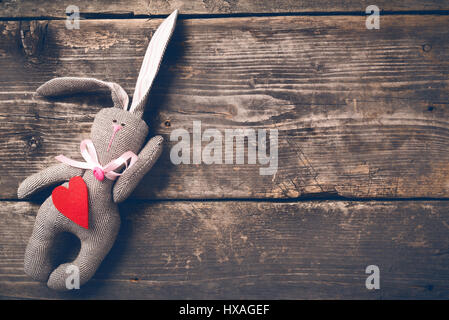 Easter bunny in a paper bag on old boards Stock Photo