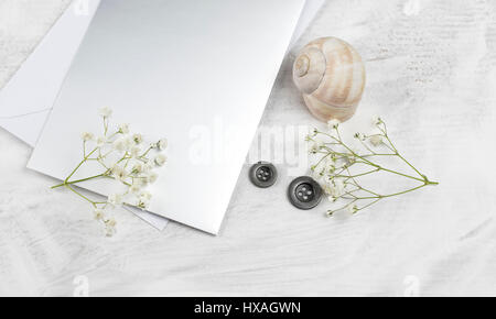 Beautiful greeting card on a table decorated with seashells and flowers Stock Photo