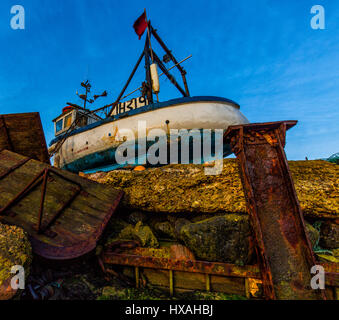 An old boat undergoing maintenance in a dry dock in Suffolk England. Stock Photo