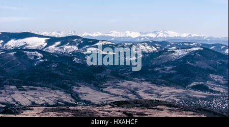 Tatras mountain range from Barania Gora hill in Silesian Beskids mountains in Poland during nice late winter day with clear sky Stock Photo