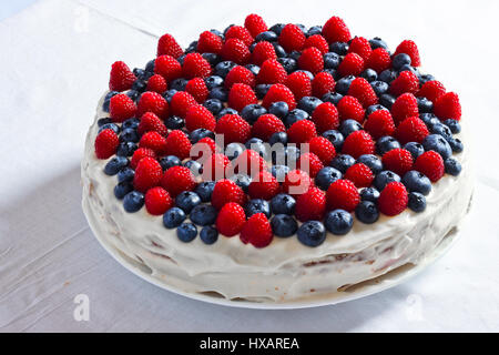 Creamy sweet cake with blueberries and raspberries Stock Photo