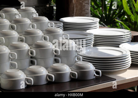 pile of  white ceramic cup and plate on table Stock Photo