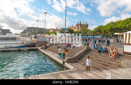 Barcelona, Spain, Nov 3rd, 2013:   Tourism in Spain, people visiting la Ramba del Mar.  Some enjoy the outdoors, some wait for their ship to come in. Stock Photo