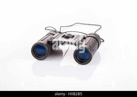 Binoculars on a white surface. Binoculars isolated on white background. Stock Photo