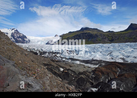 Vatnajokull or Vatna Glacier - the largest, most voluminous ice cap in Iceland, with deep crevasses, black rocks and white frozen ice and snow tongue Stock Photo