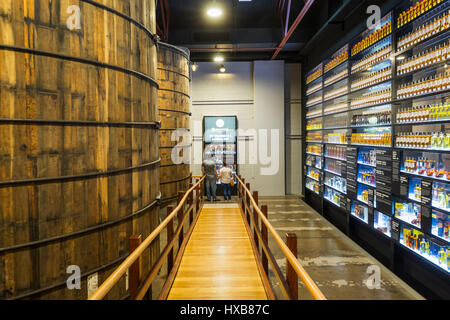 Visitors viewing the Wall of Bundy - a history of Bundaberg Rum products.  Bundaberg, Queensland, Australia Stock Photo