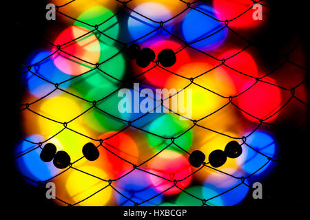 Abstract shot of colorful bokeh and fence like structures Stock Photo