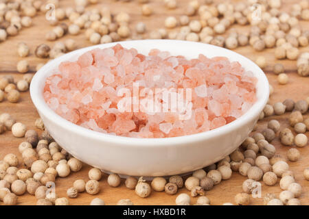 Scattered white peppercorn base with Himalayan sea salt contrast Stock Photo