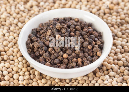 Yin Yang style with zoomed-in black peppercorn on white peppercorn base. Stock Photo