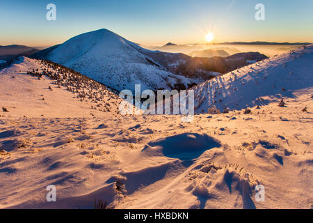 Beautiful sunrise in winter mountains Stock Photo