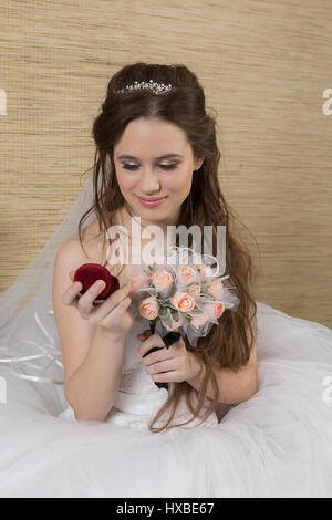 A charming bride is looking at an engagement ring. Stock Photo