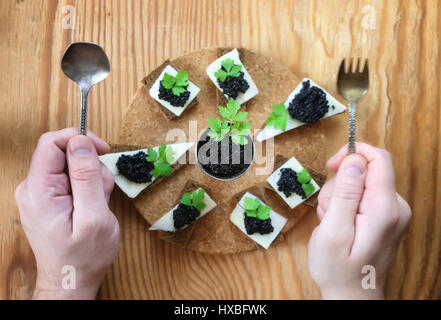 snack black caviar on a wooden background Stock Photo