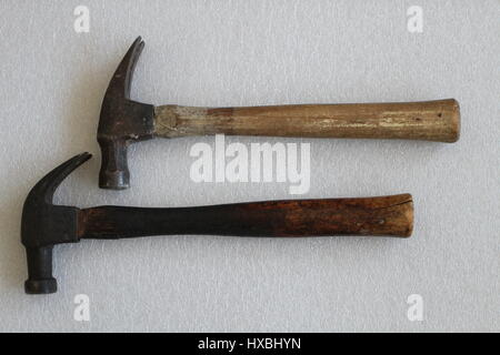Two old iron hammers with wooden handles, lying on a white background and arranged horizontally. Old hammers made in the USA. Old but reliable tools. Stock Photo