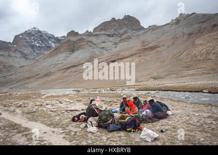 Tibetan nomad family sitting on ground near Lha Chu river en route Mount kailash kora Stock Photo