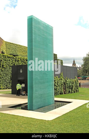 London National Police Memorial blue glass column & surround of Purbeck stone police support officer views separate roll of honour in a vitrine beyond Stock Photo