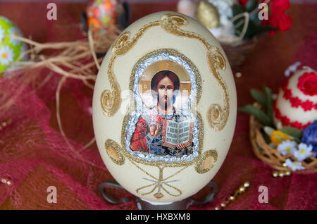 Decorated with textiles and religious motives Easter egg. Stock Photo