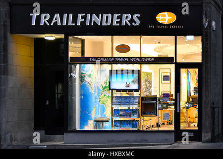Open Trailfinders Scottish travel agent interior view from outside & shop front window late afternoon winter night lighting Edinburgh Scotland UK Stock Photo