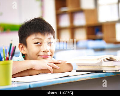 asian elementary school boy showing a funny and naughty face. Stock Photo