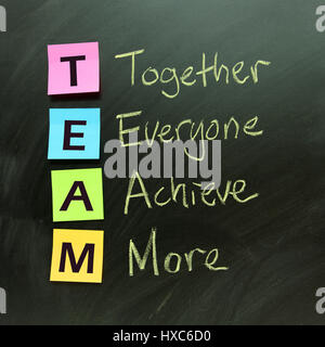 Team concept on black board indicates together everyone achieve more Stock Photo