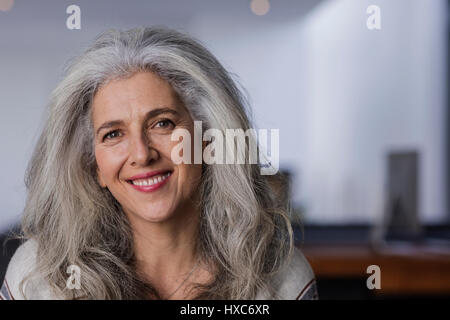 Portrait smiling mature woman with long, gray hair Stock Photo