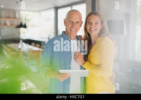 Portrait smiling couple with digital tablet Stock Photo