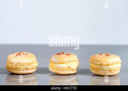 French Fourme d'Ambert macarons with Safron on top in line Stock Photo