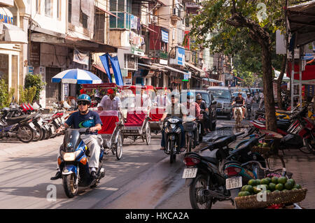 A Busy Road In Hanoi with motorbikes and bicycle transport travelling on it, Vietnam Stock Photo