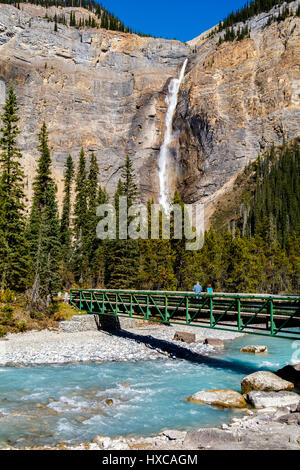 Takakkaw Falls in Yoho National Park, British Columbia, Canada. Fed by the Daly Glacier. River crossing in the foreground. Stock Photo