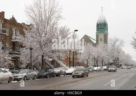 Montreal, Canada - 25 March 2017: Christophe-Colomb Street and Paroisse Saint-Arsene church in winter Stock Photo