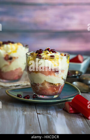 White chocolate mousse with poached rhubarb garnished with pomegranate seeds Stock Photo
