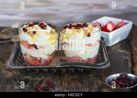 White chocolate mousse with poached rhubarb garnished with pomegranate seeds Stock Photo