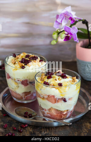 White chocolate mousse with poached rhubarb garnished with pomegranate seeds Stock Photo