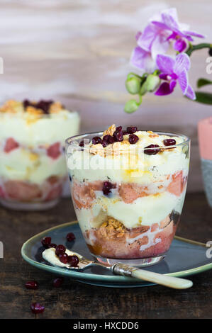 White chocolate mousse with poached rhubarb garnished with pomegranate seeds Stock Photo