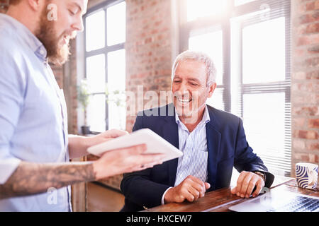 Businessmen with digital tablet working in office Stock Photo