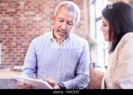 Businessman and businesswoman using digital tablet Stock Photo